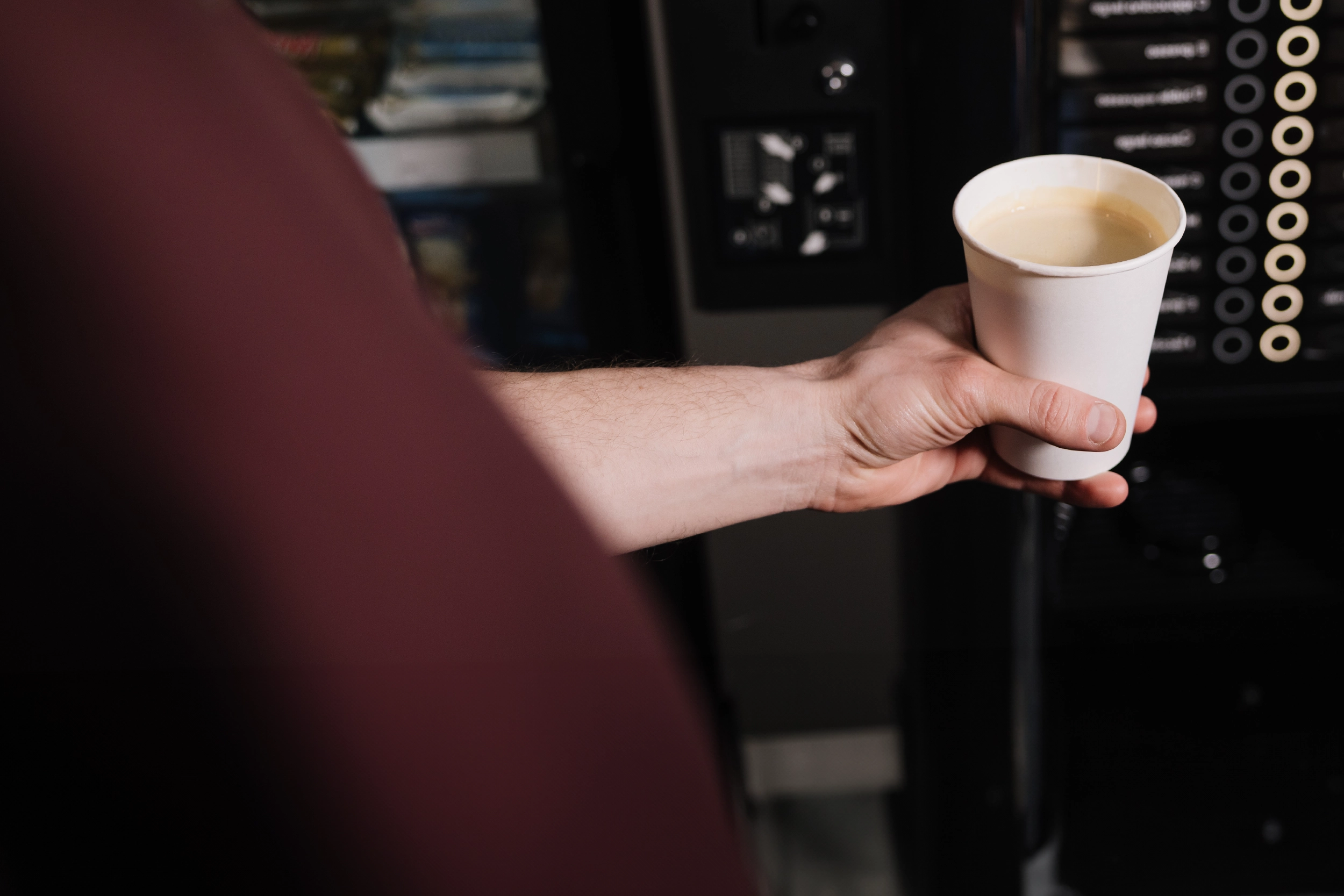 Drinking coffee by vending machine